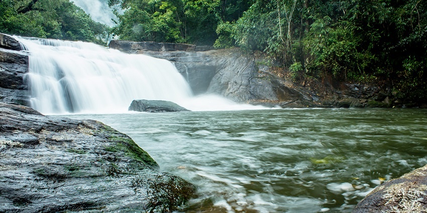 An image of a stunning waterfall showcasing the clear water and soothing atmosphere