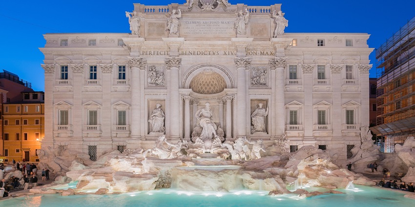 A group of tourists enjoying at the Trevi Fountain, a ritualistic thing to do in Rome