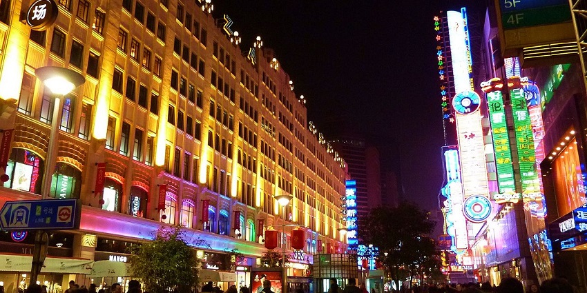 Image of Shanghai nightlife people strolling by the street and vibrant lights