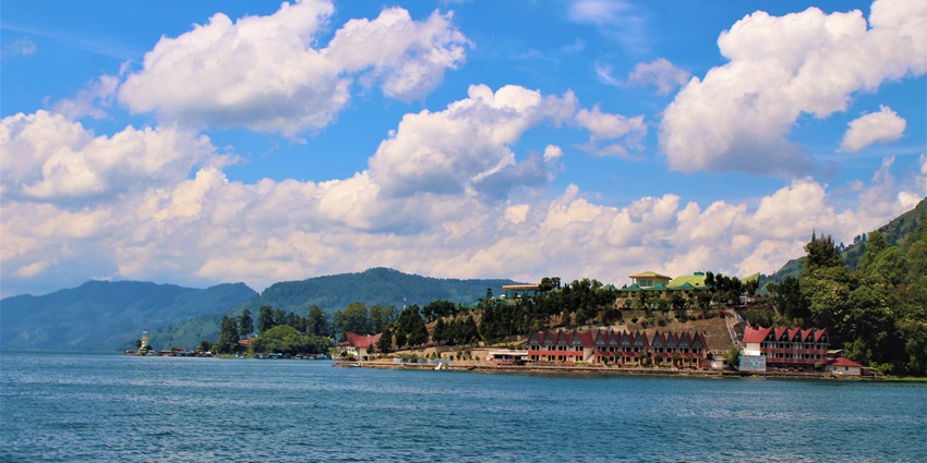 Toba Lake with a big water body, buildings near the lake - one of the lakes in Asia.