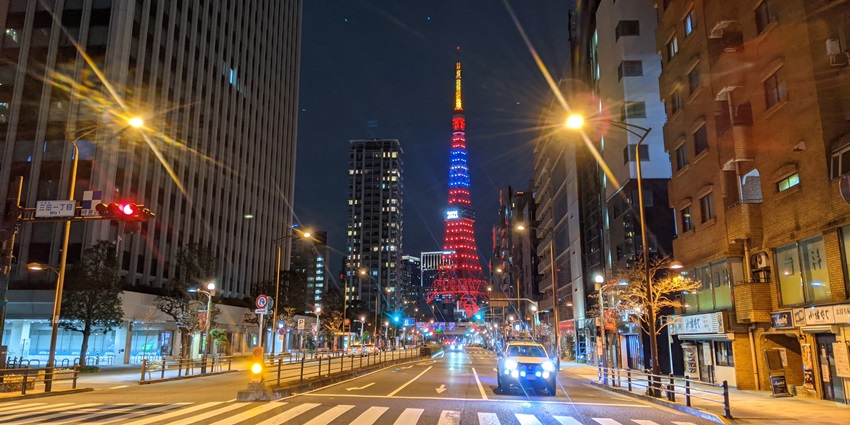 Image of Iconic red tower offering panoramic city views at night with vibrant lights