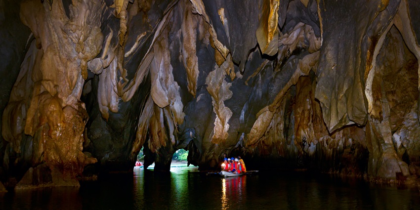 Explore an enchanting subterranean river with unique rock formations in Palawan island.