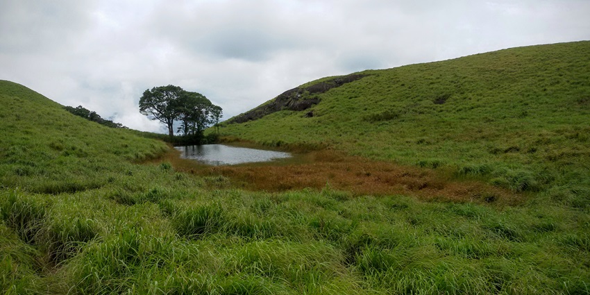 View of the Heart-Shaped Lake in Chembra Peak in monsoons with clouds in the background