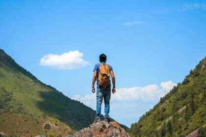 A man standing on the top of the hills while trekking in Aravali Hills in Gurgaon