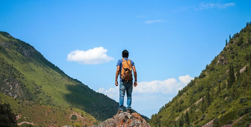 A man standing on the top of the hills while trekking in Aravali Hills in Gurgaon