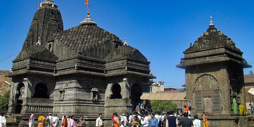 Trimbakeshwar Shiva Temple built of black stone near Godavari’s source under blue sky
