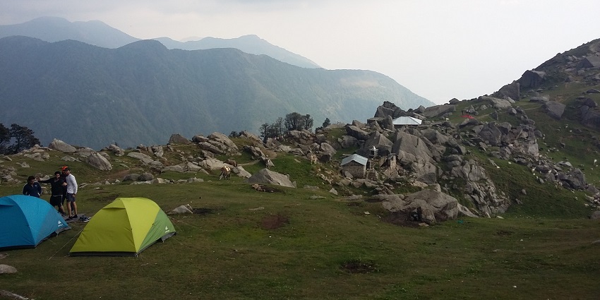 An image of camp setups in the Triund Trek in Himachal Pradesh with mesmerizing views