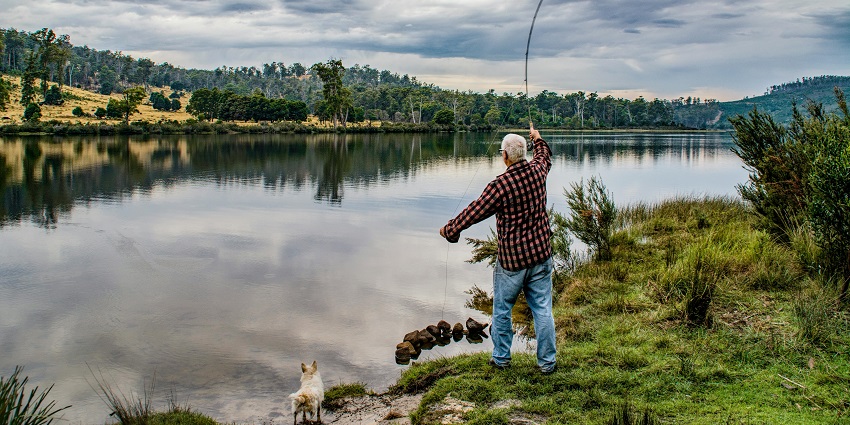 A picture of a local fisherman feeding the birds and fishes.
