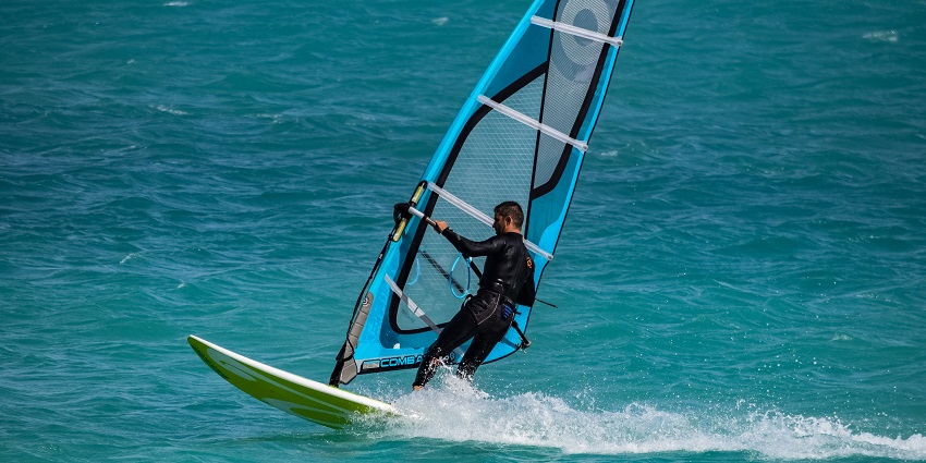 A man navigates his way in the open waters during windsurfing in a sea.
Viewers of this file can see comments and suggestions