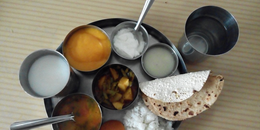 An image showing undhiyu and chikki, traditional delicacies enjoyed during Uttarayan, the harvest festival of Gujarat.