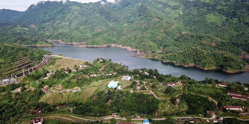 Tuirial Lake from above with the Tuirial dam and buildings in greenery and hills