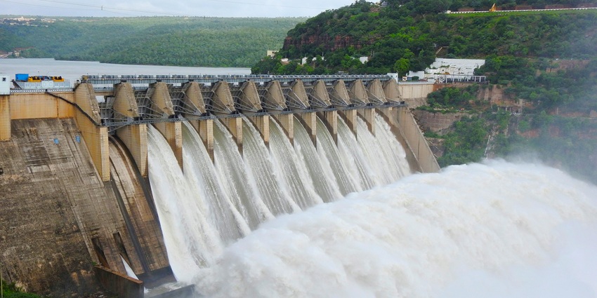 Explore the scenic Tumaria Dam with calm waters and green hills in Uttarakhand, India.
