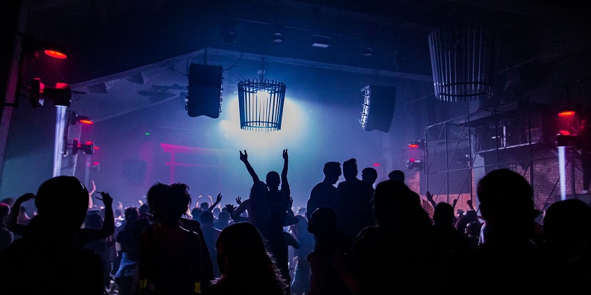 Lively crowd dancing creating a vibe like Uitto Pub and enjoying Finland nightlife