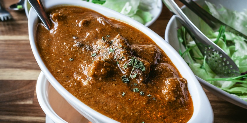 Indulge in Vada Curry, a lentil fritter delight, typically served as a breakfast side dish.