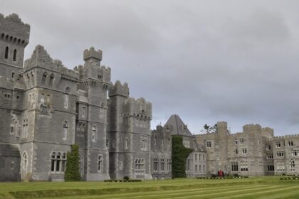 An image showing Ashford Castle by the lake, an ideal spot for Valentine’s Day in Ireland.