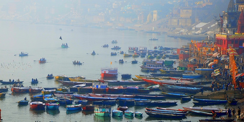 An image of pilgrims performing rituals at the ghats along the Ganges River in Varanasi.