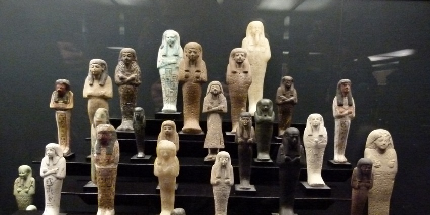 Collection of ancient Egyptian artefacts, mummies, and statues.