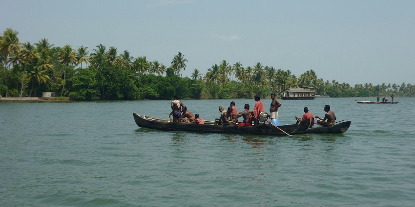 A houseboat floating on the peaceful waters of Vembanad Lake, one of the lakes in Kerala.