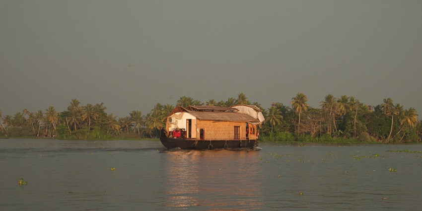 An image of Vembanad Lake, one of the famous lakes in India, with houseboats.