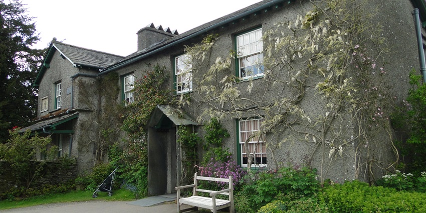 An image of the Hill Top Farm, the former home of Beatrix Potter, surrounded by greenery