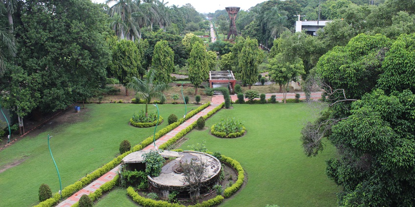 Panoramic view of the Butterfly Park covered with lush greenery and a narrow lake