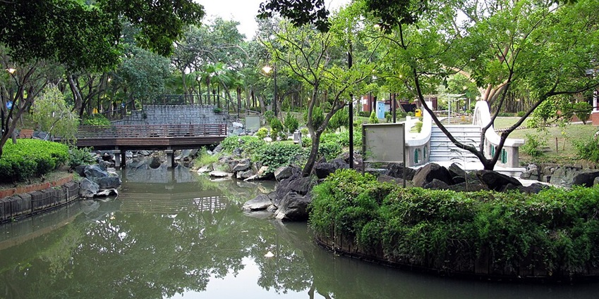 Panoramic view of the Butterfly Park covered with lush greenery and a narrow lake