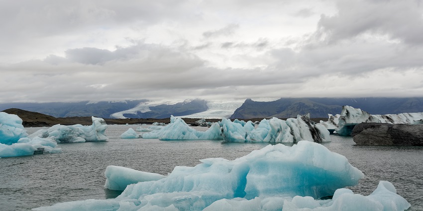 An image showing the serene Glacier Lagoon in Iceland, surrounded by floating icebergs.