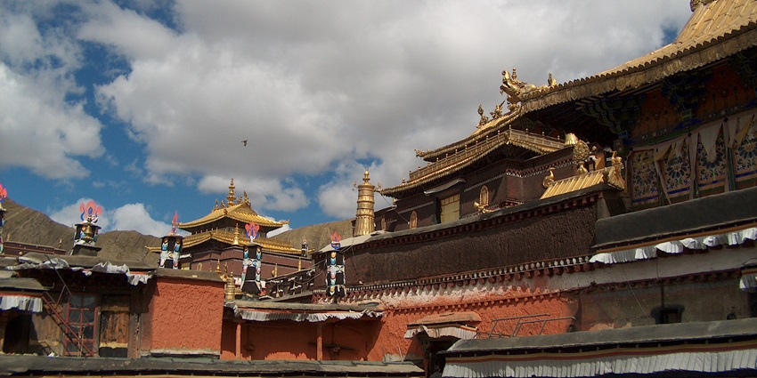 The grand Panchen Lama's Palace with golden rooftops, intricate carvings, and red walls