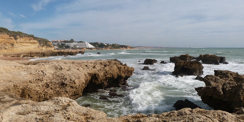 An image of the stunning cliffs and beach view of the Algarve Coast in Portugal