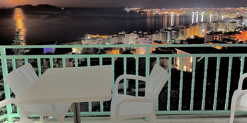 A view of a dinner table setup and the Bay of Vlore from a top restaurant in Vlore.