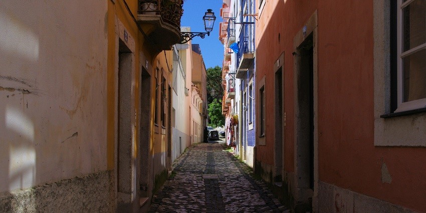 An image of a street in Lisbon’s historic Alfama District among things to do in Portugal.