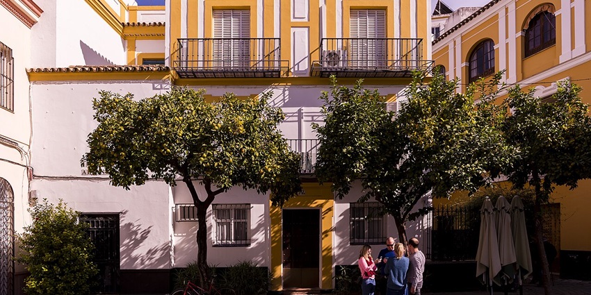 Tourists wandering on the vibrant streets of Santa Cruz, a fun thing to do in Seville