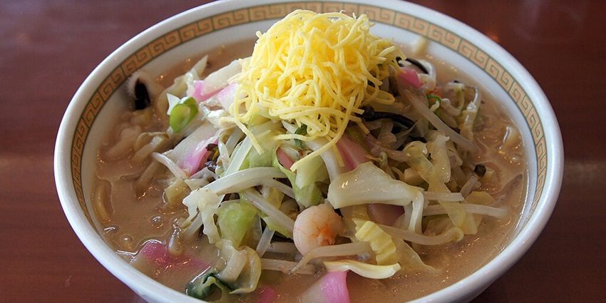 A bowl of champon noodles at Shikairo, topped with seafood, pork, and vegetables.
