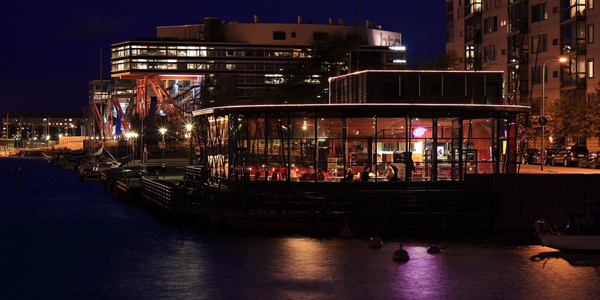 An image of Night view of a restaurant filled with customers enjoying their food.