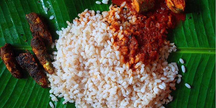 Try a Kerala dish with white rice and fish curry during your trip to the heart shaped lake in India.
