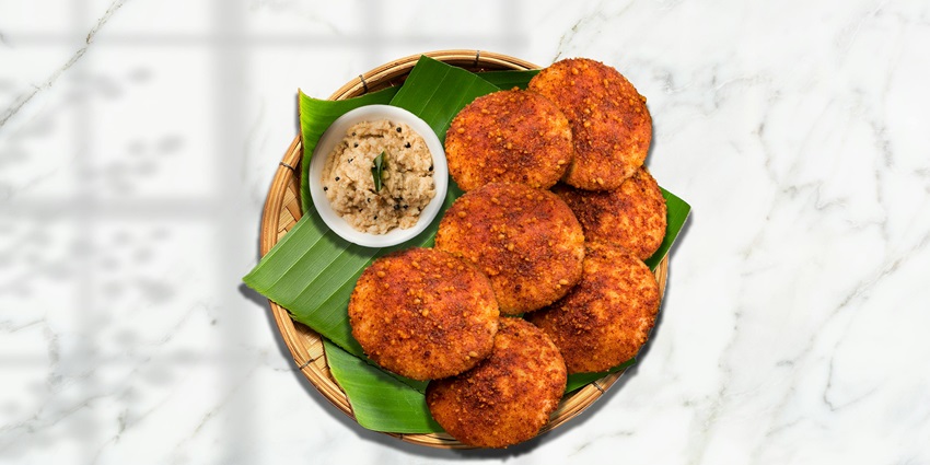 Traditional meal of Kerala with idlis and different chutneys served on banana leaf.
