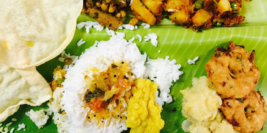 An image of local South Indian food dishes being served at a restaurant in Coimbatore.