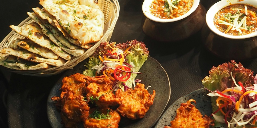 A variety of flavorful Indian dishes, showcasing rich spices and traditional cooking techniques.