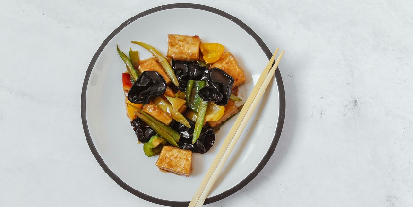 Image of A Chinese Food in the Plate with Chopsticks served on a bowl