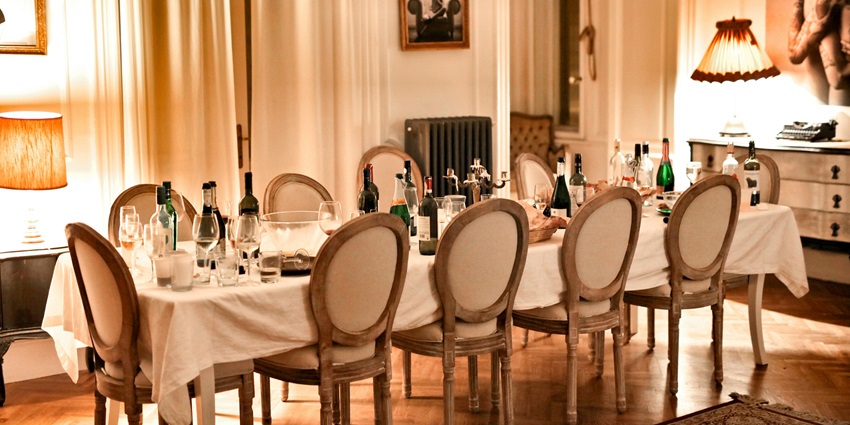 An image showing a cosy restaurant setup with brown chairs and dining tables prepared for guests.