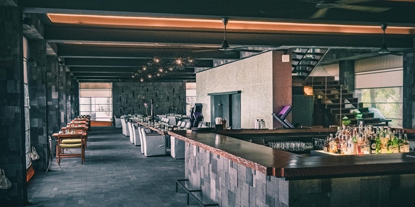 An image showing a sophisticated restaurant interior with modern furniture and dark accents.
