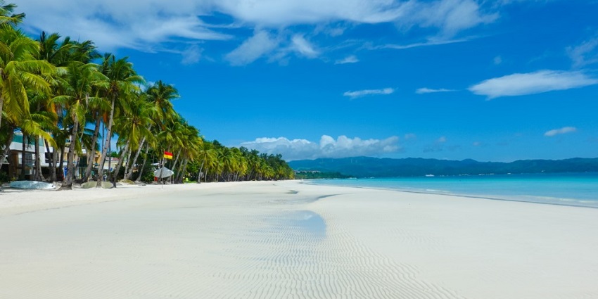 Image of pristine beach with soft white sand and crystal-clear waters