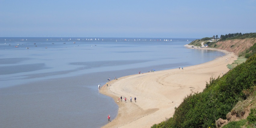 Diverse coastal landscapes featuring sandy beaches, nature reserves, and trails.