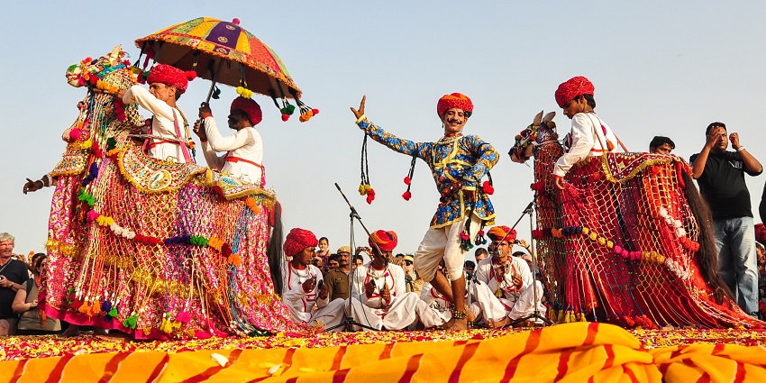 folk dancers in colorful ethnic attire performing in cultural festival