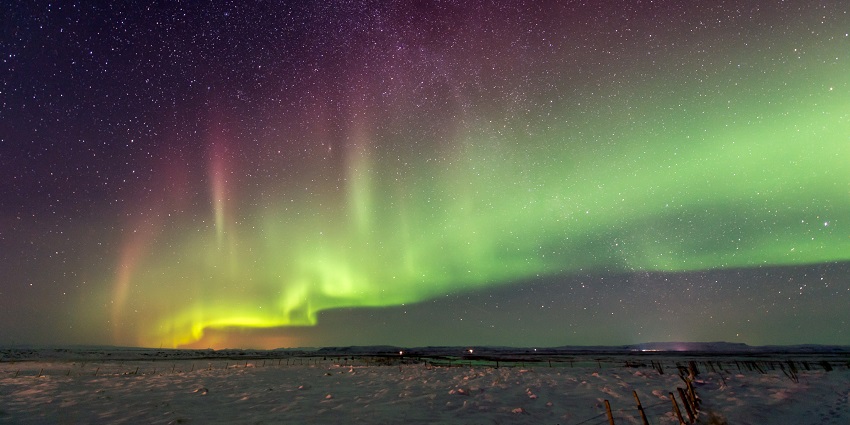 Image of the Northern Lights illuminating the sky, the best place for Valentine’s Day in Iceland.