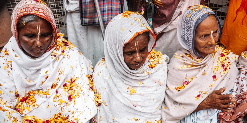 Widows dressed in white sarees celebrate Holi with flowers, breaking old stereotypes.