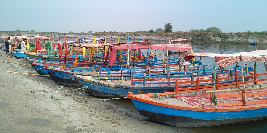 Image of boat parked at Yamuna River in India around beautiful valleys