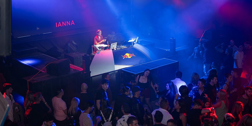 A buzzing nightlife spot with neon lights, pulsating music, and an electrifying dance floor.