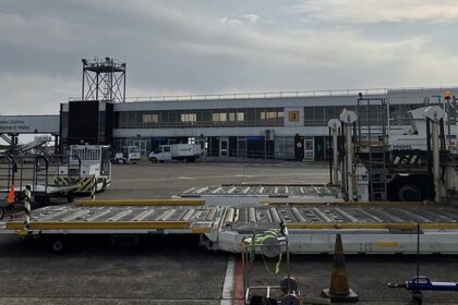 A glimpse of an aeroplane on a runway in the evening getting started to take off.