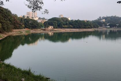 Ulsoor Lake, one of the famous lakes in Bangalore, from a distance with a small water body surrounded by greenery.